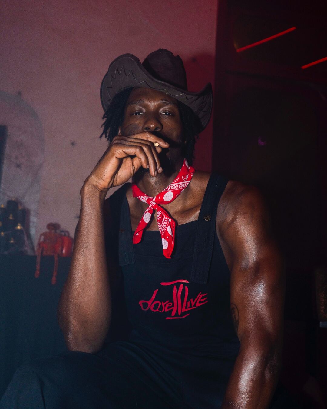 Cowboy hat portrait in Dare To Live overalls